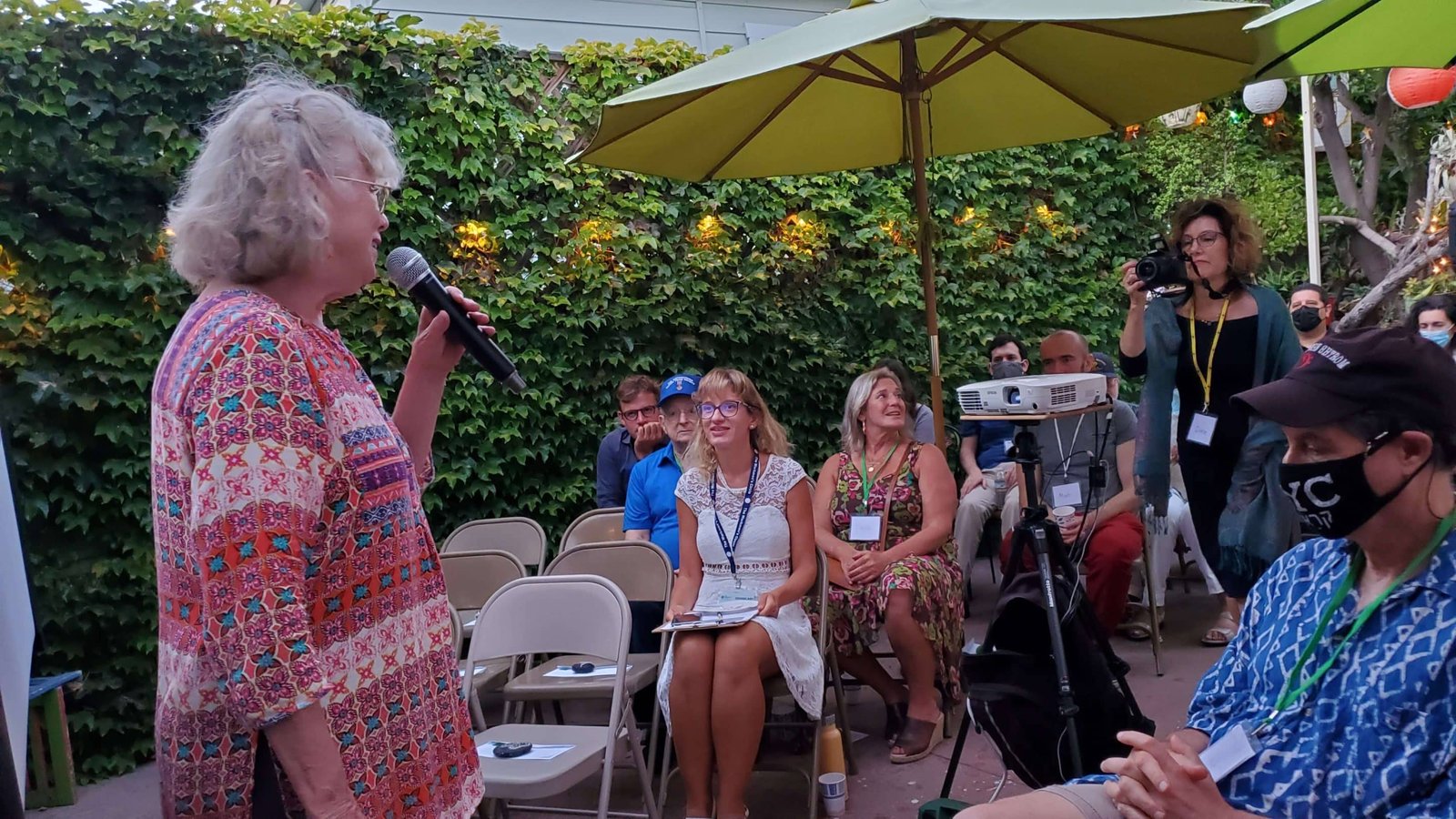 An image of a woman speaking to a small crowd.