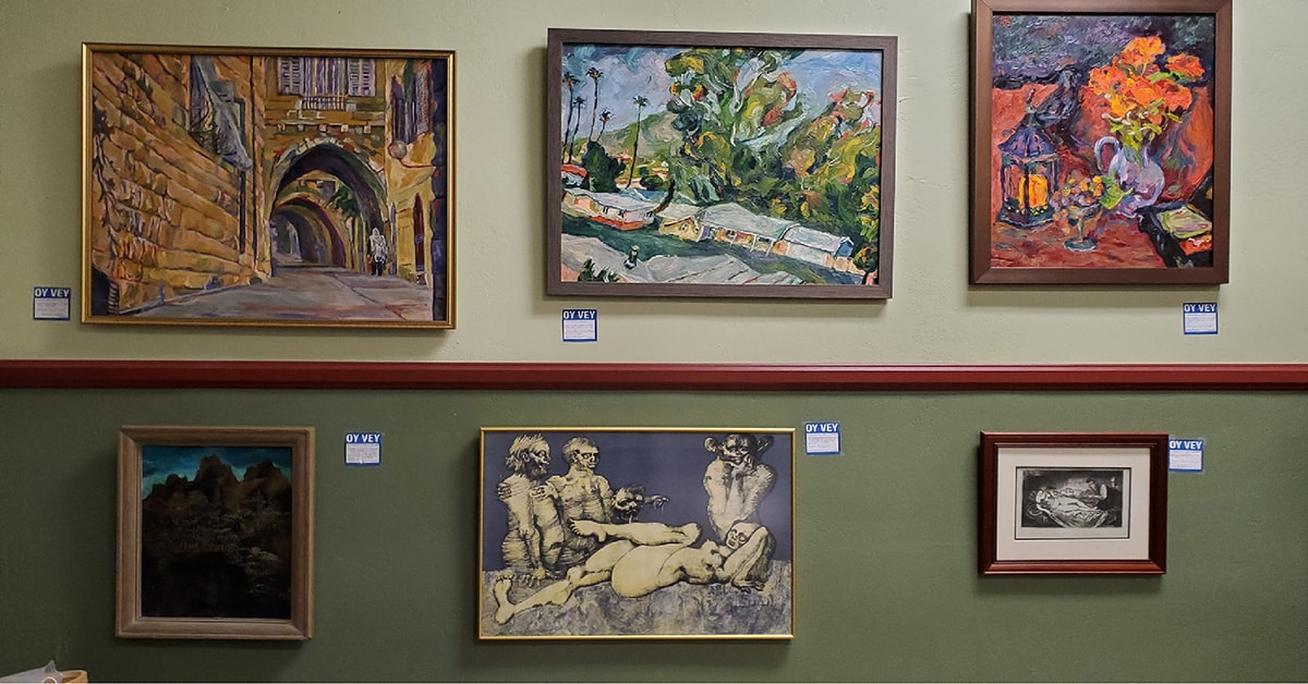 a wall displaying six paintings of various subjects, like architecture, landscape, and humans