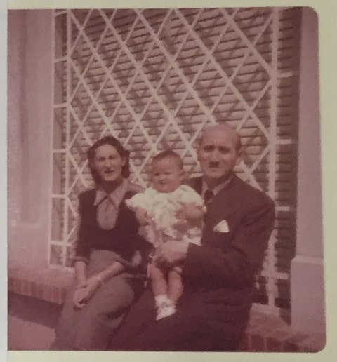 a couple, man and woman, holding a girl child