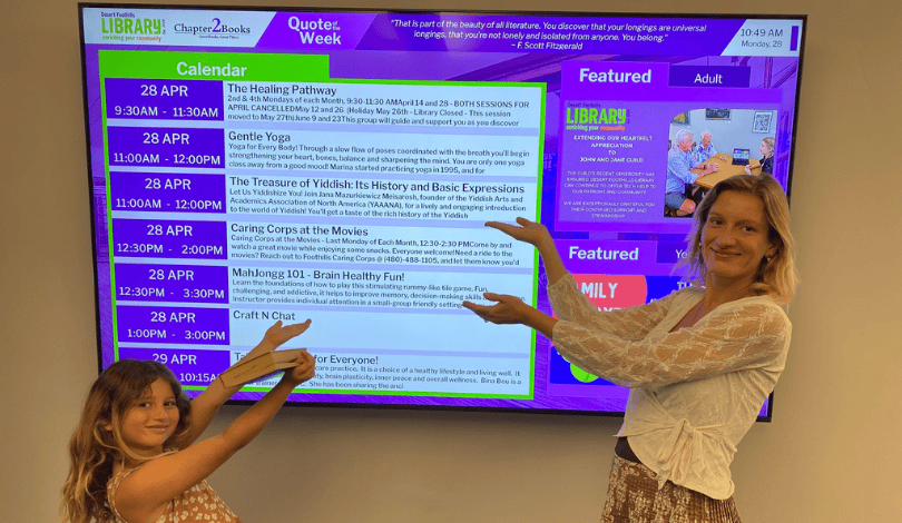 A photograph of La Paz, a beach town with palms, surfers, ocean and mountains