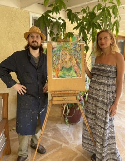 Oleg Tsank standing beside a finished Yiddish portrait with the model at Yiddishland California.